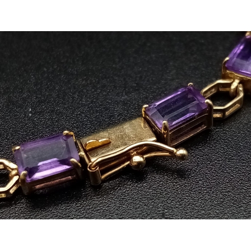 69 - A Vintage 9K Gold Amethyst Tennis Bracelet. 18cm. 7.83g total weight.