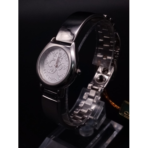 335 - A ladies COIN WATCH in original presentation box. 25 mm case, stainless steel construction, in new/u... 