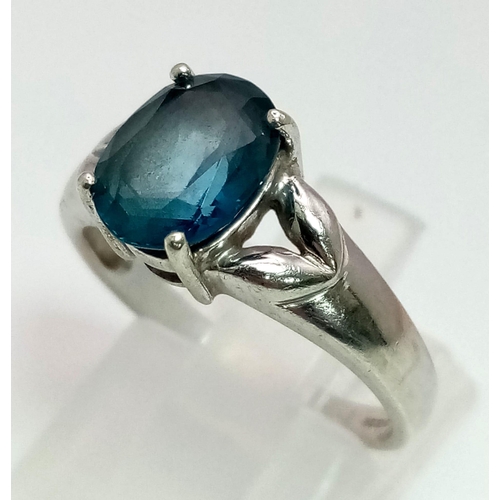 1309 - A 9K White Gold Blue Topaz Ring. Size N. 3.07g total weight.