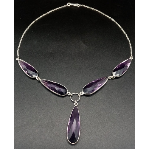 272 - A very elegant silver necklace, earrings and ring set with elongate, tear-drop, faceted amethysts. N... 