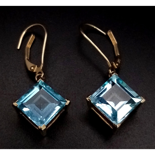 547 - A Pair of 9K Yellow Gold Blue Stone Earrings. 4.03g total weight.