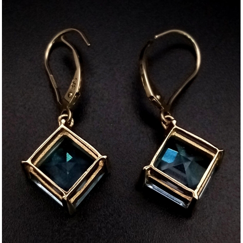 547 - A Pair of 9K Yellow Gold Blue Stone Earrings. 4.03g total weight.