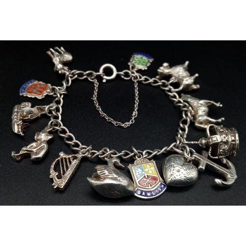 925 - A Vintage Silver Charm Bracelet. 12 charms. 39.28g