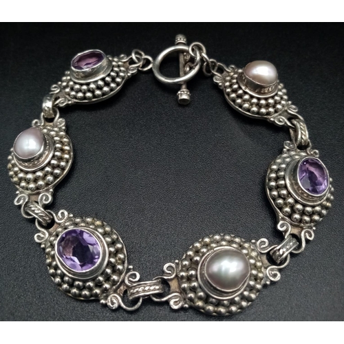 1338 - A Vintage Amethyst and Pearl Bracelet. Each piece sits in a nest of tiny balls. 22cm. 36.45g total w... 