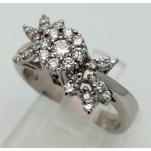 102 - An 18K White Gold Diamond Floral Burst Ring. Over 1ct of bright white diamonds create this stand out... 