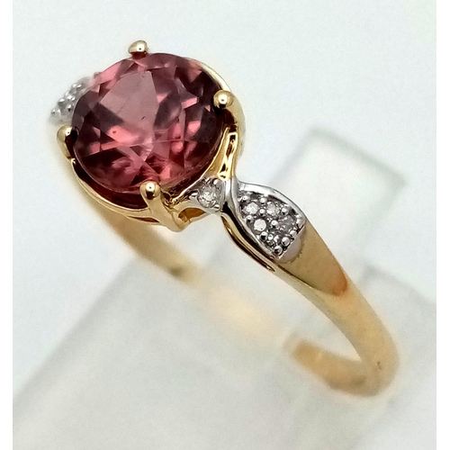 1039 - A 10K Yellow Gold Pink Gemstone and Diamond Ring. Size S.
2.41g total weight.