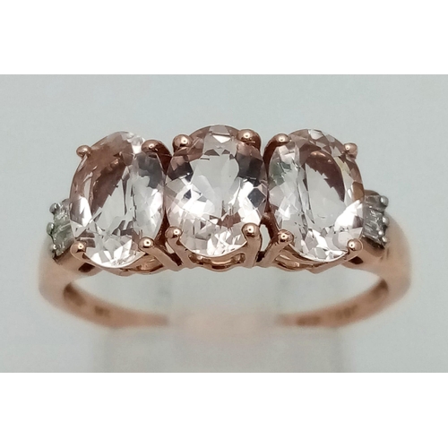 1044 - A 10K Rose Gold Trilogy White Gemstone Ring. Size P 1/2. 2.05g total weight