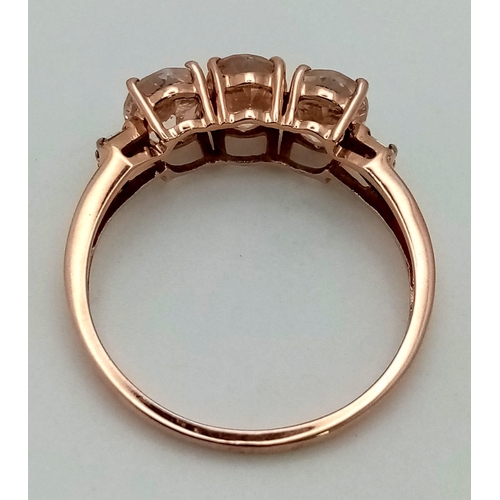 1044 - A 10K Rose Gold Trilogy White Gemstone Ring. Size P 1/2. 2.05g total weight