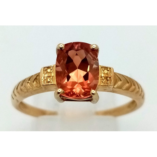 1046 - A 10K Yellow Gold Orange Spinel Solitaire Ring. Size S. 2.18g total weight.