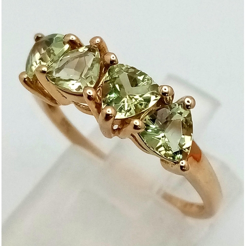 1058 - A 10k Yellow Gold Four Peridot Gemstone Ring. Four clean trillion cut gemstones. Size P 1/2. 2.54g t... 