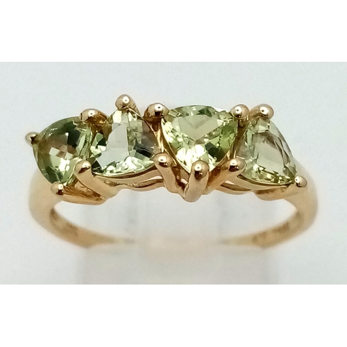 1058 - A 10k Yellow Gold Four Peridot Gemstone Ring. Four clean trillion cut gemstones. Size P 1/2. 2.54g t... 