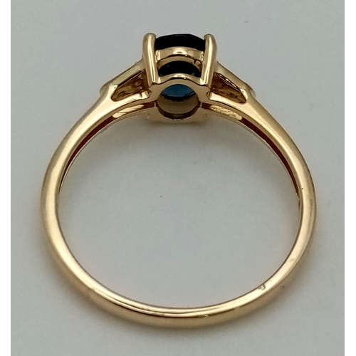 1060 - A 10K Yellow Gold Blue Topaz and Diamond Ring. Central oval topaz with diamonds on shoulders. Size R... 