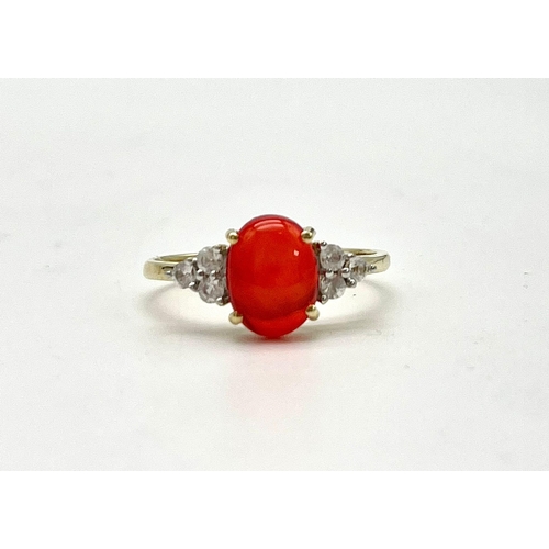 1067 - A 10K Yellow Gold Red Rodochrosite and White Stone Ring.
Size P 1/2. 1.89g total weight.