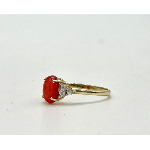 1067 - A 10K Yellow Gold Red Rodochrosite and White Stone Ring.
Size P 1/2. 1.89g total weight.