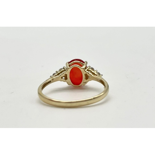 1067 - A 10K Yellow Gold Red Rodochrosite and White Stone Ring.
Size P 1/2. 1.89g total weight.