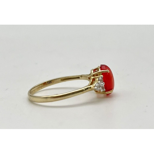 1067 - A 10K Yellow Gold Red Rodochrosite and White Stone Ring.
Size P 1/2. 1.89g total weight.