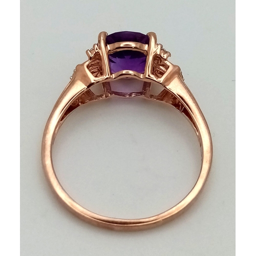 1072 - A 10K Rose Gold Amethyst and Diamond Ring. Lovely round cut, clean amethyst with small diamonds on s... 