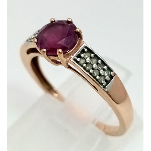 1487 - A 9K Rose Gold Pink Topaz and Diamond Ring. Central circular cut topaz with small diamonds on wings.... 