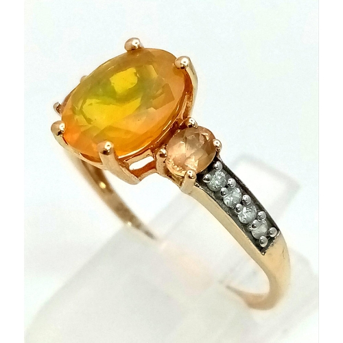 1489 - A 10K Yellow Gold Opal and Diamond Ring. Central oval opal with lemon quartz and small diamonds on w... 