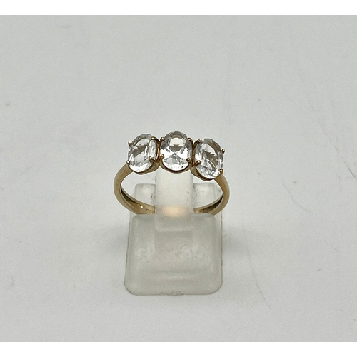 1495 - A 10K Yellow Gold White Quartz Trilogy Ring. Size N 1/2. 2g total weight.