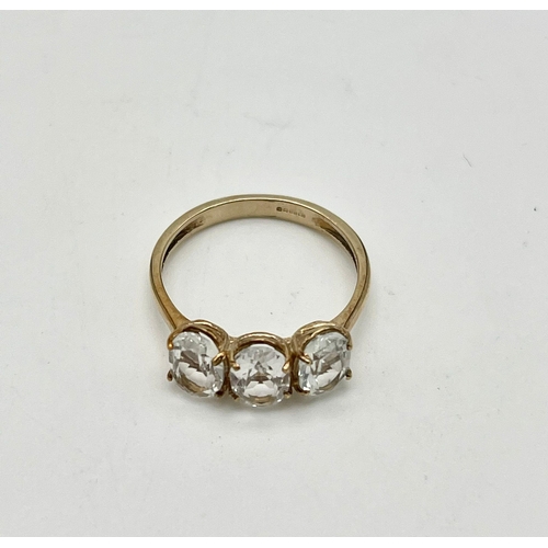 1495 - A 10K Yellow Gold White Quartz Trilogy Ring. Size N 1/2. 2g total weight.