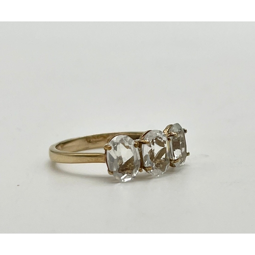 1495 - A 10K Yellow Gold White Quartz Trilogy Ring. Size N 1/2. 2g total weight.