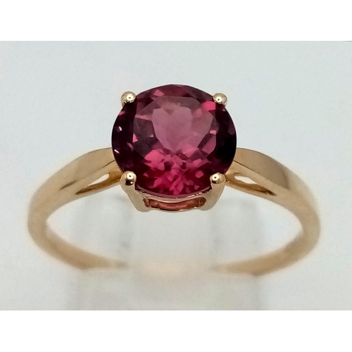 1499 - A 10K Yellow Gold Pink Tourmaline Ring. Central round cut tourmaline. Size R. Total weight - 2.1g