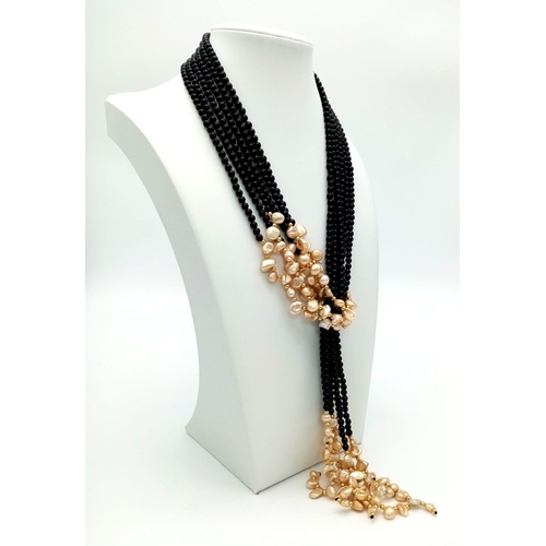 153 - An amazing, Belle Epoque reminiscent necklace. Three long strands (130 cm) of black onyx and cream c... 