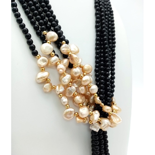 153 - An amazing, Belle Epoque reminiscent necklace. Three long strands (130 cm) of black onyx and cream c... 