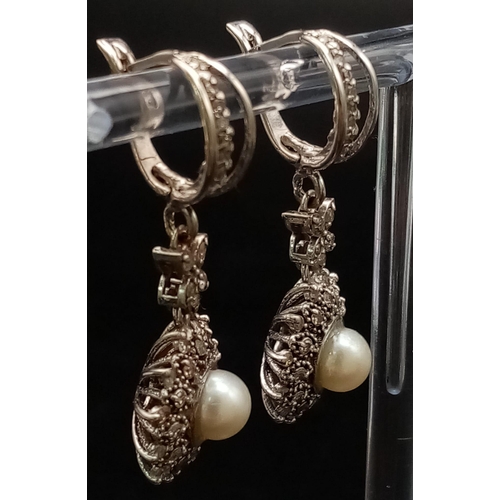 297 - An Art Deco Style 18K White Gold Diamond and Cultured Pearl Jewellery Set. Includes: A pair of earri... 