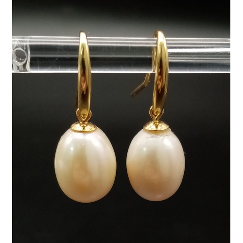 380 - A Pair of 9K Yellow Gold and Cultured Pearl Earrings. 15mm pearls. 4.25g total weight