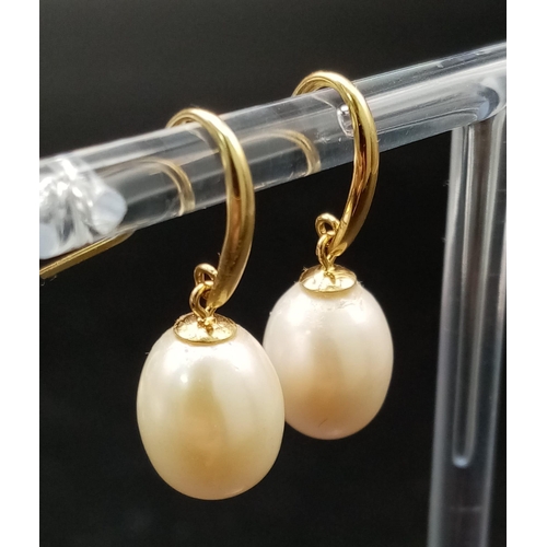 380 - A Pair of 9K Yellow Gold and Cultured Pearl Earrings. 15mm pearls. 4.25g total weight