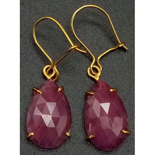 696 - A Pair of 9K Yellow Gold and Ruby Teardrop Earrings. 2.59g total weight.