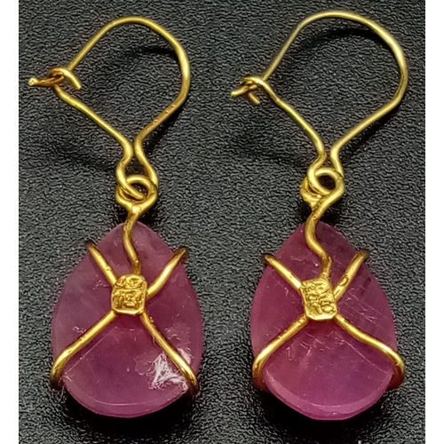 696 - A Pair of 9K Yellow Gold and Ruby Teardrop Earrings. 2.59g total weight.