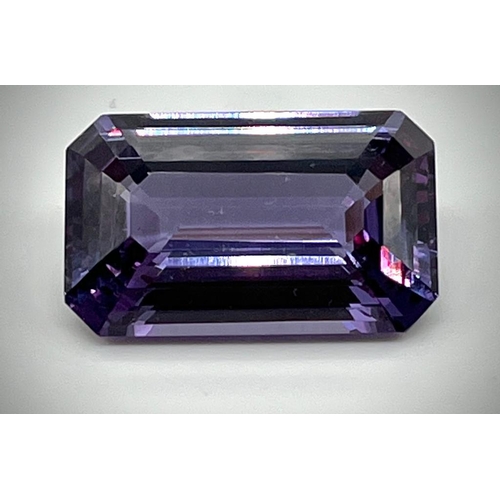 732 - A 32ct Purple/Blue Gemstone. Emerald cut with no visible inclusions. 23 x 14 x 9mm. Heat treated. No... 