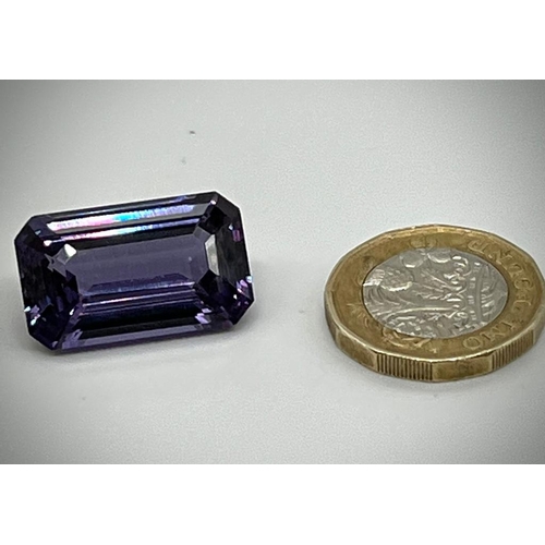 732 - A 32ct Purple/Blue Gemstone. Emerald cut with no visible inclusions. 23 x 14 x 9mm. Heat treated. No... 