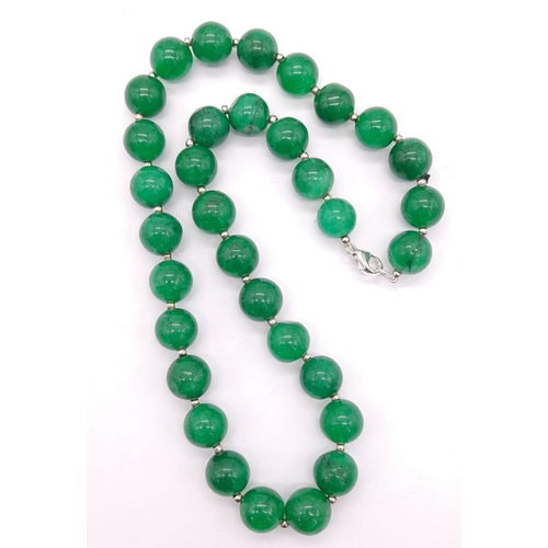 895 - A Jade Bead Necklace with Silver Clasp. Beads - 12mm. 46cm.