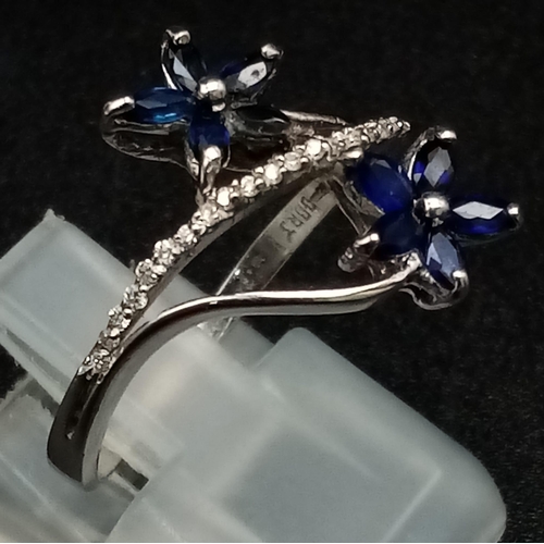 909 - An 18K White Gold Diamond and Sapphire Floral Burst Ring. 3.35g total weight. Size M/N.