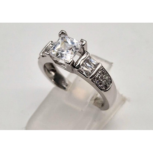 187 - A 9K white gold ring with princess cut cubic zirconia. Ring size: M1/2, weight: 4.4 g.