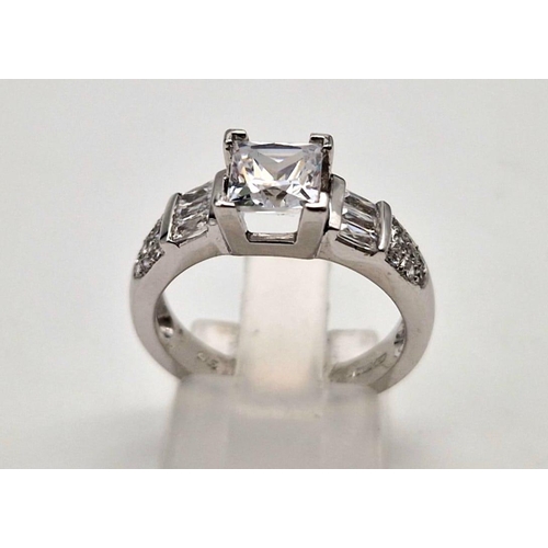 187 - A 9K white gold ring with princess cut cubic zirconia. Ring size: M1/2, weight: 4.4 g.