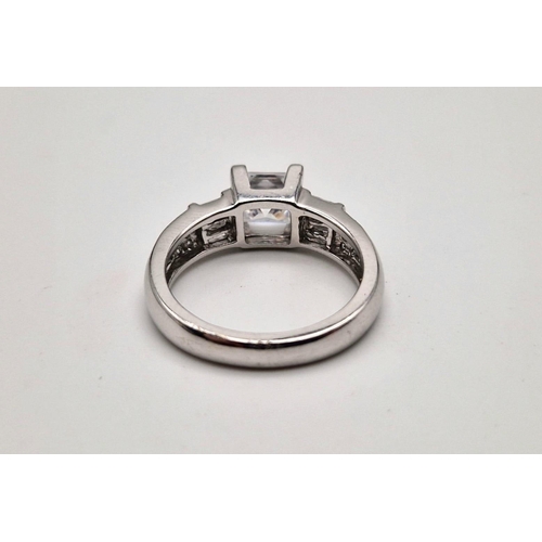 187 - A 9K white gold ring with princess cut cubic zirconia. Ring size: M1/2, weight: 4.4 g.