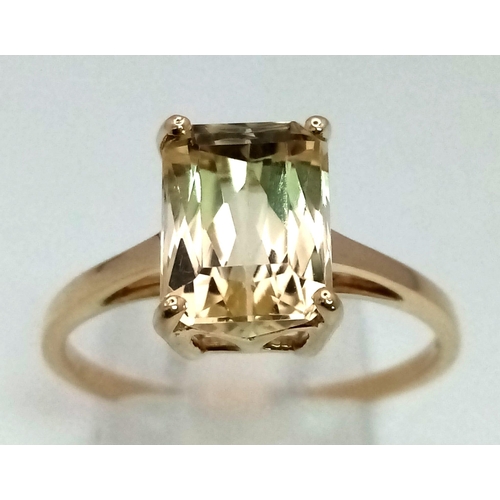 374 - A 10K Yellow Gold Lemon Quartz Solitaire Ring. Emerald cut central stone. Size R 1/2. Total weight -... 