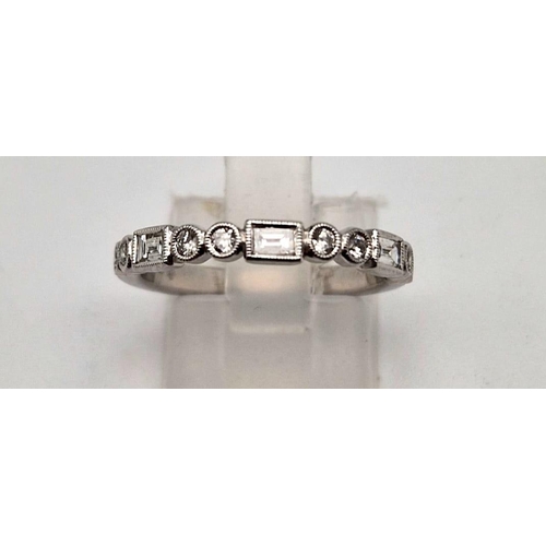 407 - A fine 9K white gold half eternity ring with round cut and baguette diamonds. Ring size: M1/2, weigh... 