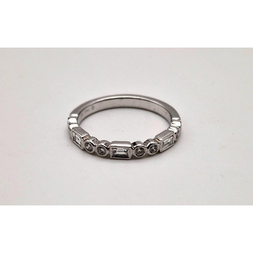 407 - A fine 9K white gold half eternity ring with round cut and baguette diamonds. Ring size: M1/2, weigh... 