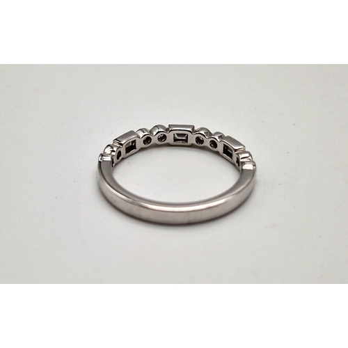 407 - A fine 9K white gold half eternity ring with round cut and baguette diamonds. Ring size: M1/2, weigh... 