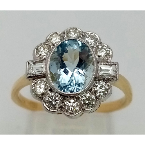 615 - A gorgeous 18K gold ring with a large, oval cut aquamarine, surrounded by a halo of round cut diamon... 