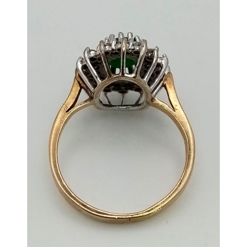 622 - A vintage, 9k yellow gold ring with a central oval cut emerald (1 carat appr.), surrounded by a doub... 