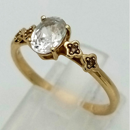 1500 - A 10K Yellow Gold White Quartz and Diamond Ring. Oval cut white quartz with two small diamonds eithe... 