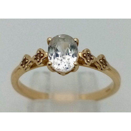 1500 - A 10K Yellow Gold White Quartz and Diamond Ring. Oval cut white quartz with two small diamonds eithe... 