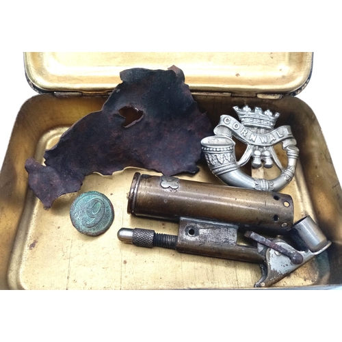 576 - WW1 British Tommie’s Xmas Tin Circa 1914. Containing a cap badge, button, shrapnel and trench lighte... 